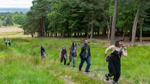 Visitors walking in the parkland at Lyme Park, Cheshire